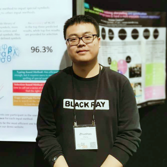 Zhuohao Zhang at CHI 2019 standing in front of a poster, wearing a black sweater.